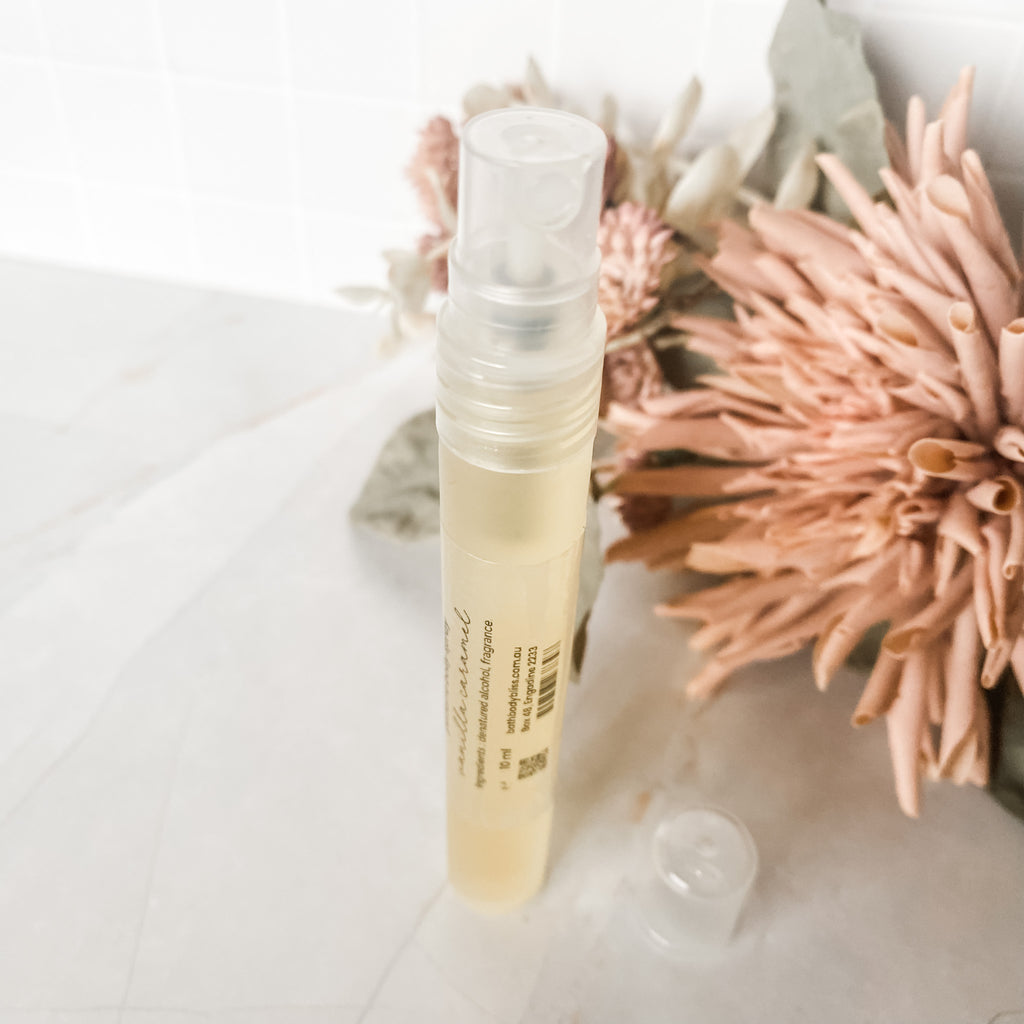 single 10ml perfume spray bottle on a light background with flower decor