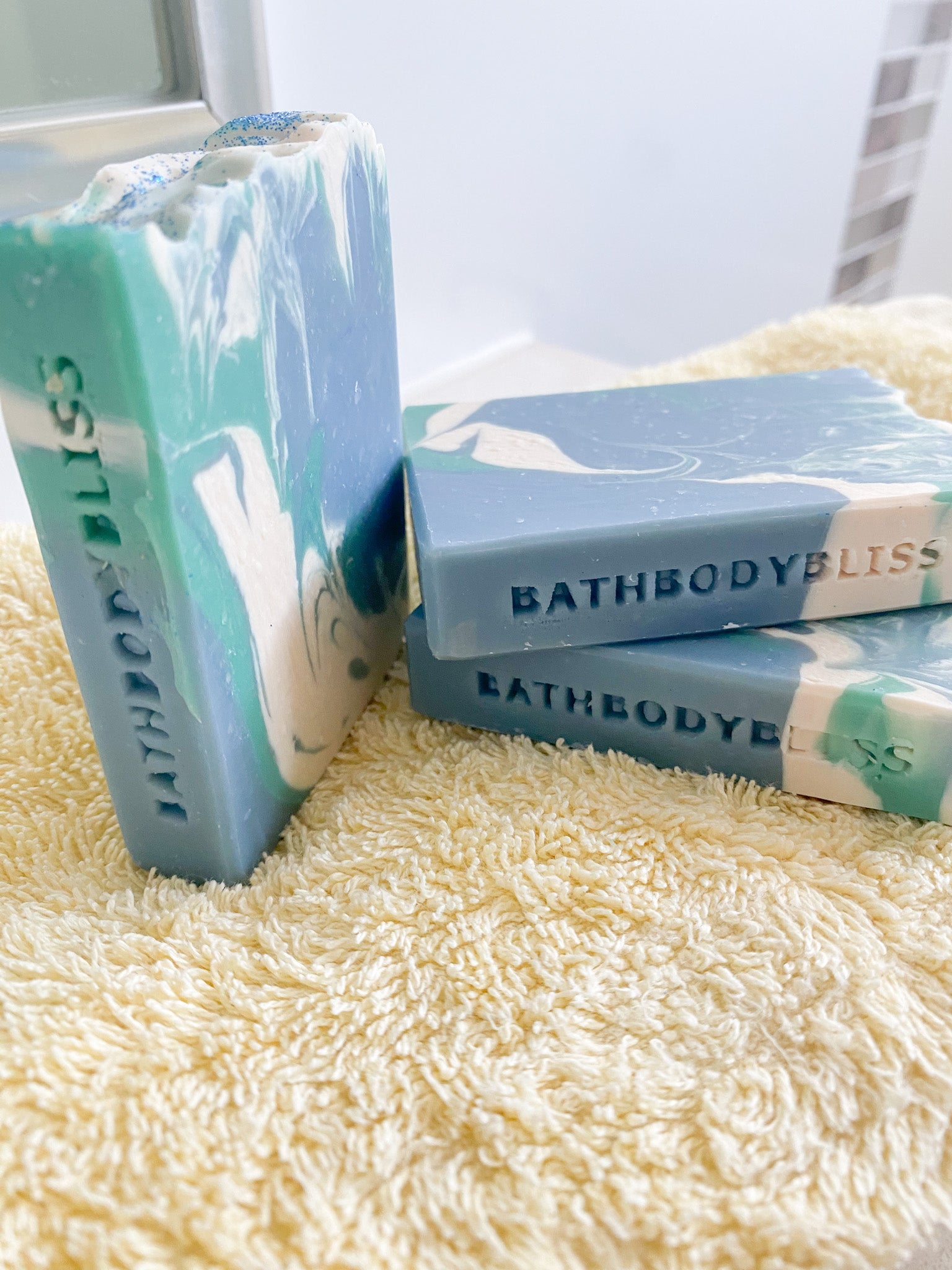Bathbody Bliss soap bars on a textured surface