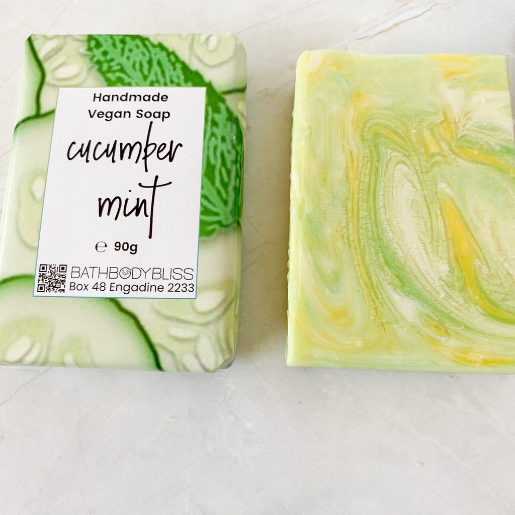 on wrapped and one unwrapped, swirled green, yellow & white cucumber mint soap bars