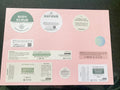 Pink packaging with multiple labels for a body scrub product