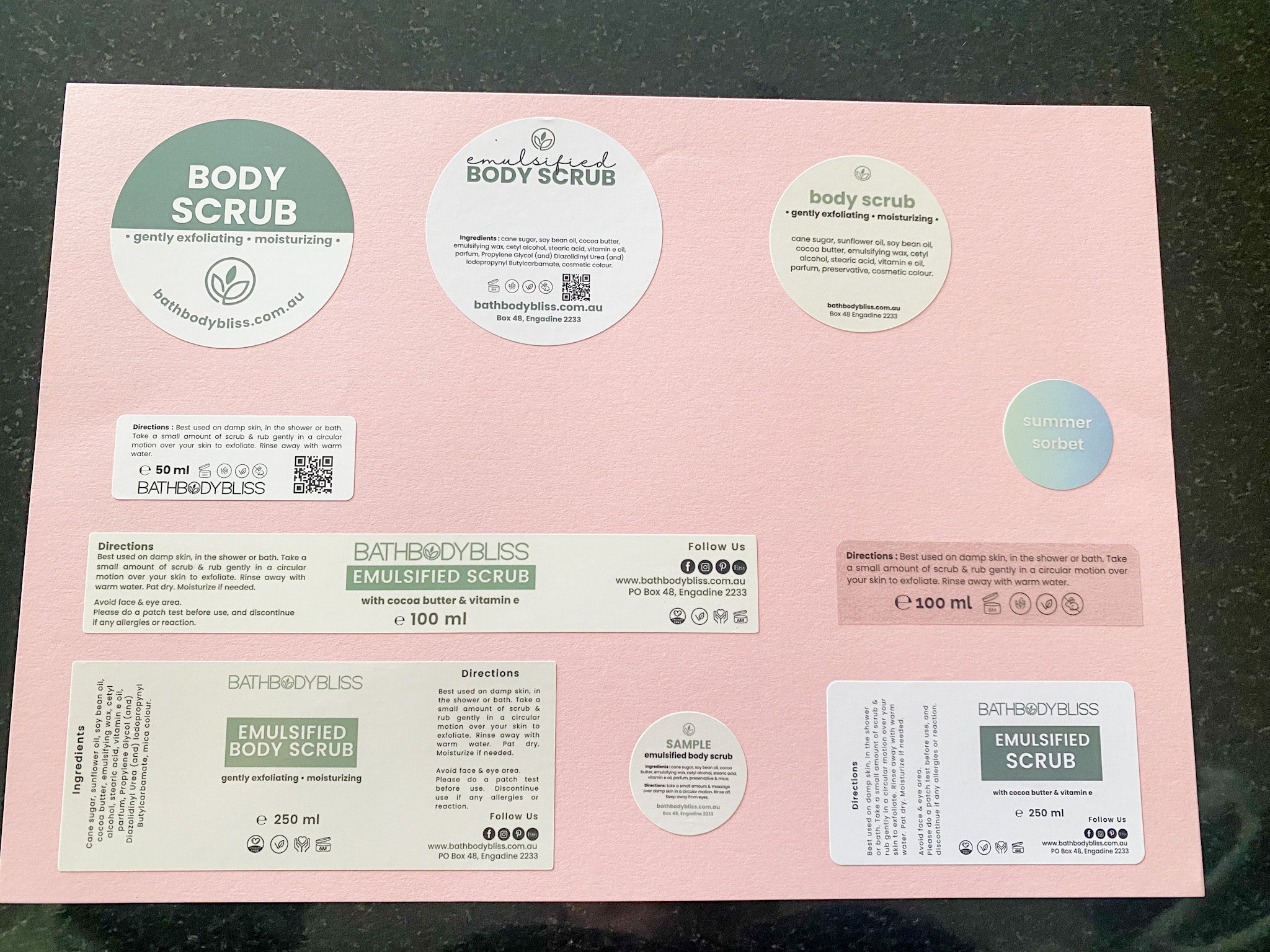 Pink packaging with multiple labels for a body scrub product