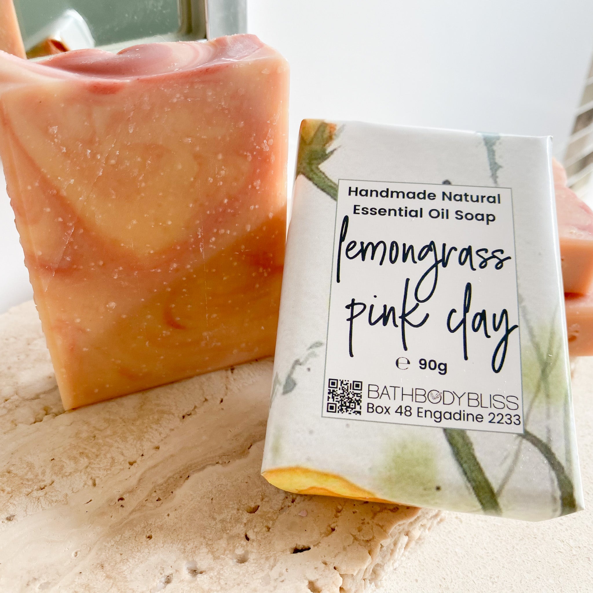 Handmade natural essential oil soap with lemongrass pink clay scent on a light background