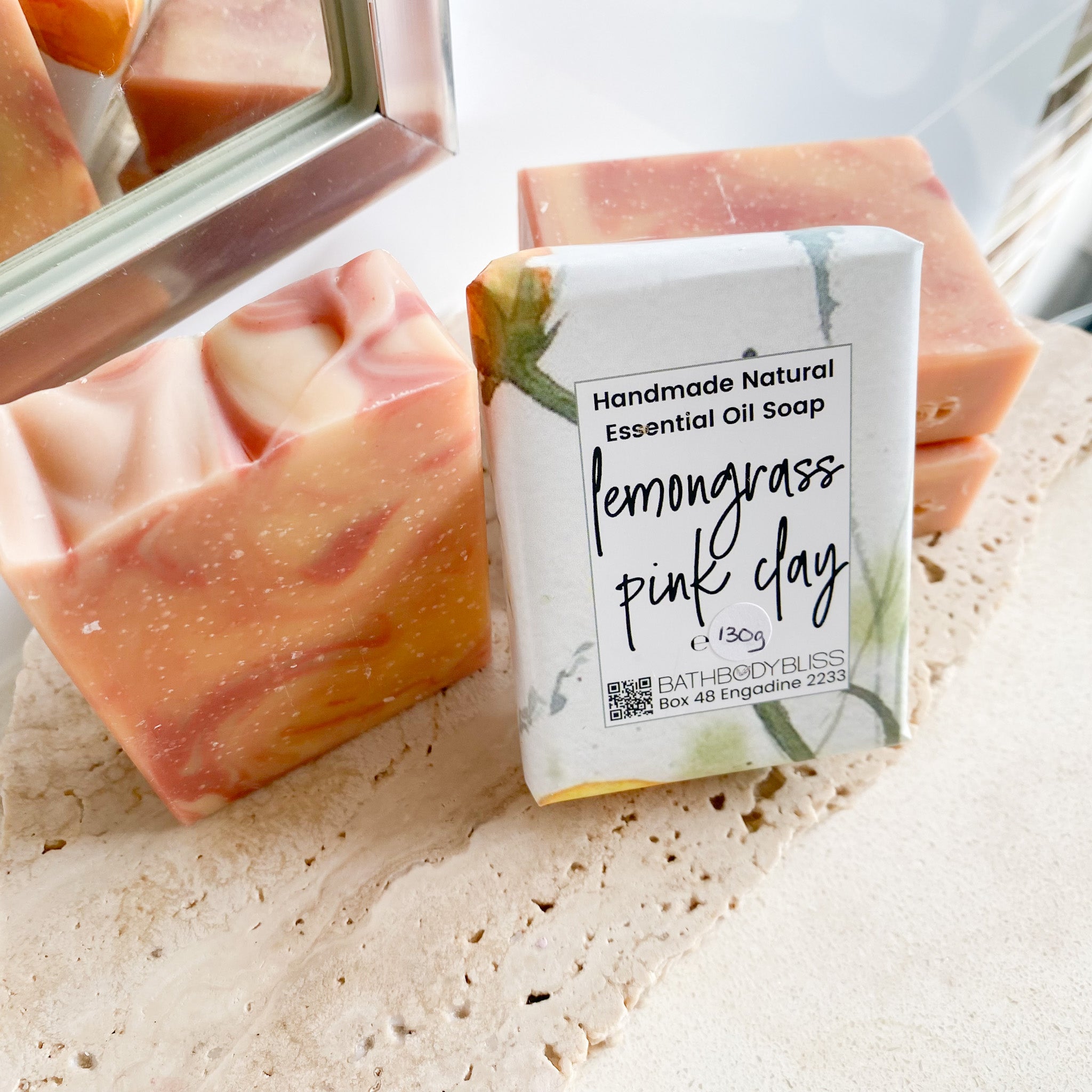 Handmade natural essential oil soap with a label on a textured surface