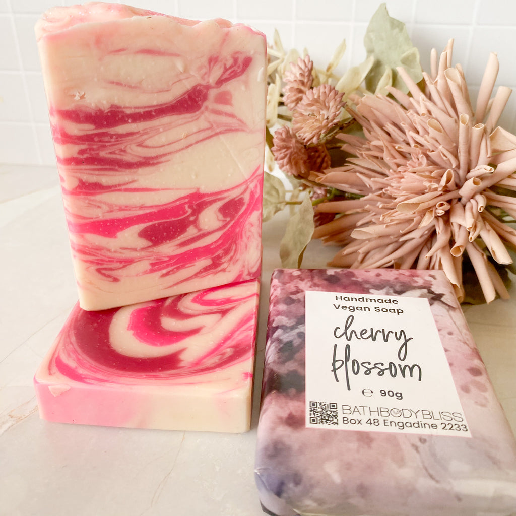 pink and white stacked soap bars with wrapped cherry blossom soap package & floral decor