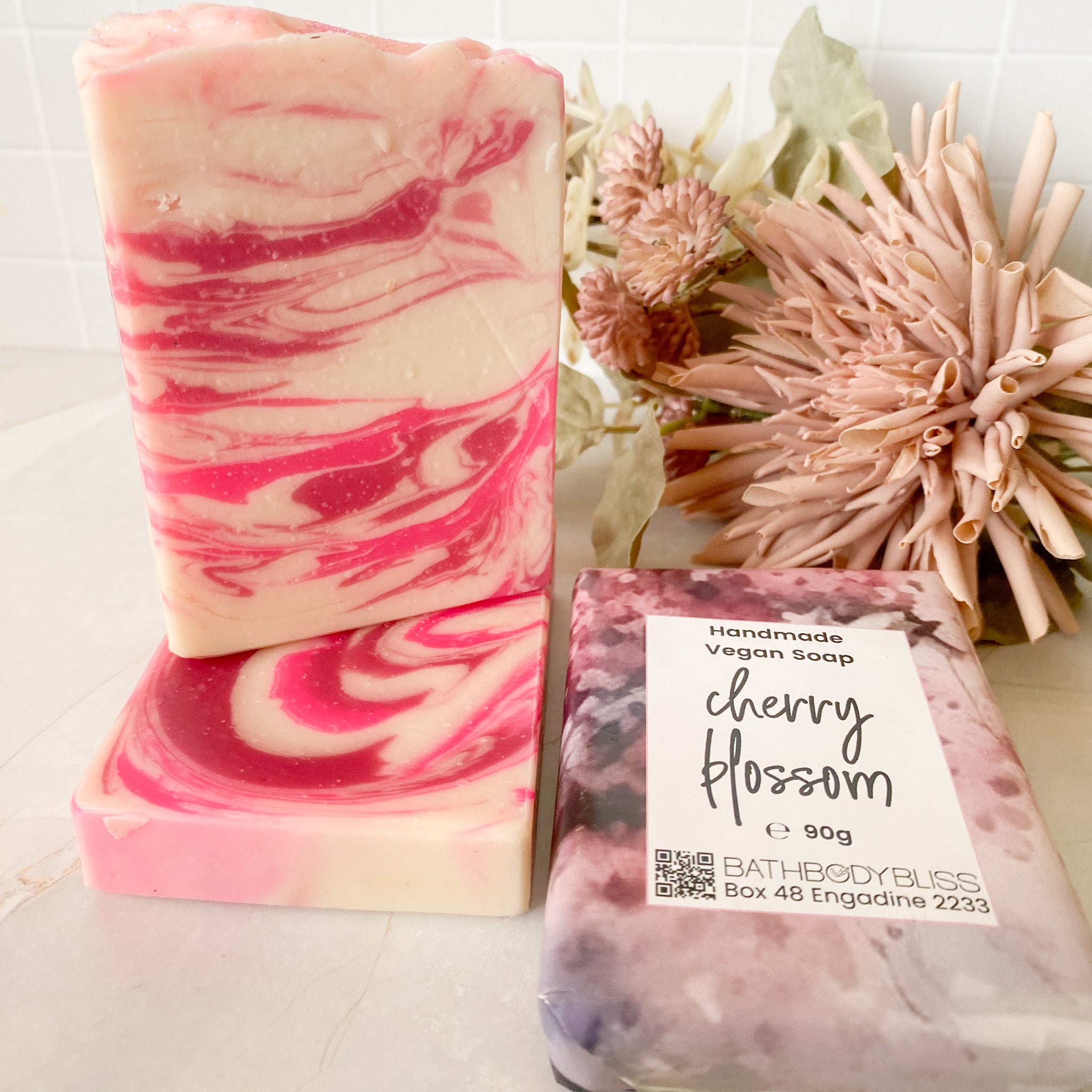 pink and white stacked soap bars with wrapped cherry blossom soap package & floral decor
