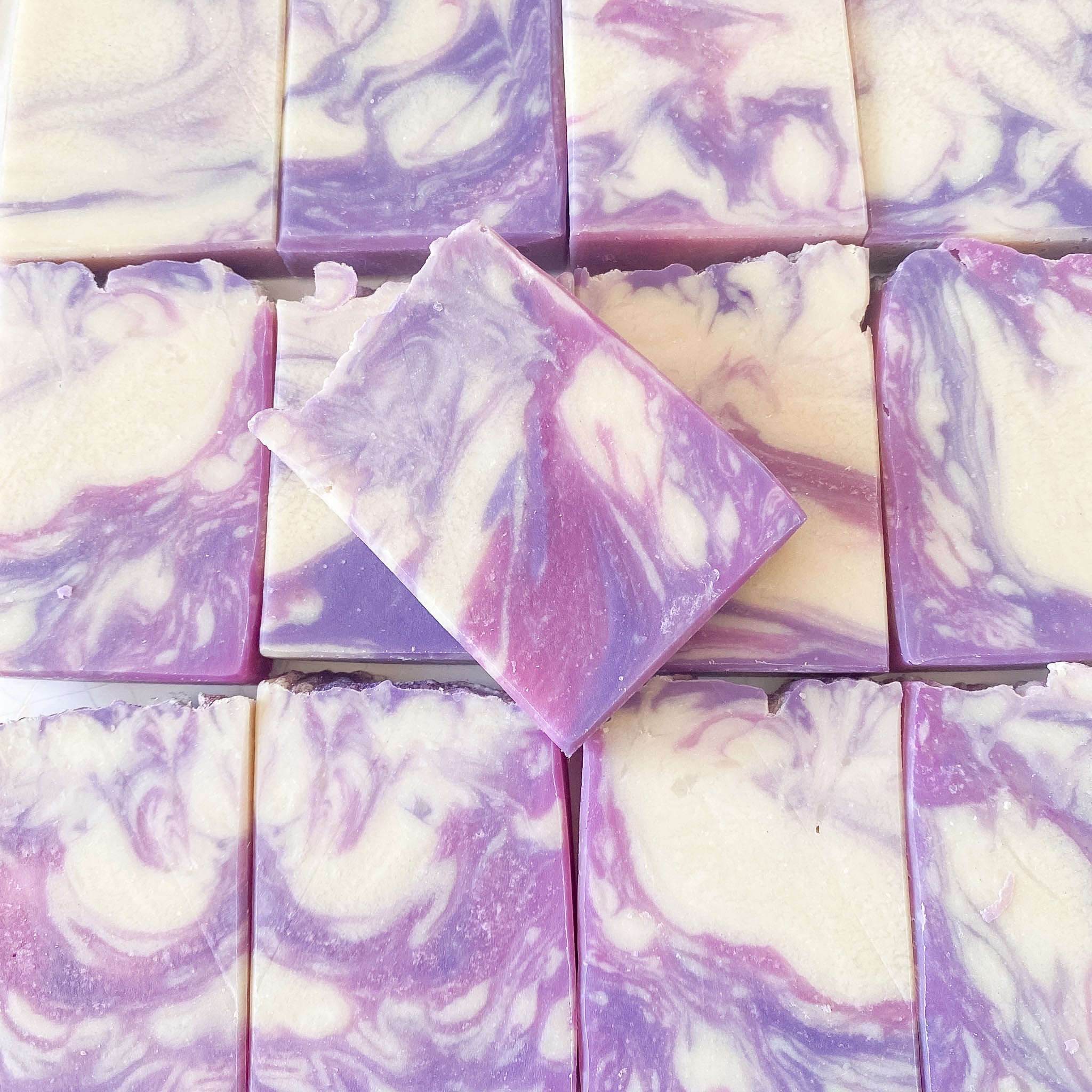 Swirl patterned soap bars in shades of purple and white.