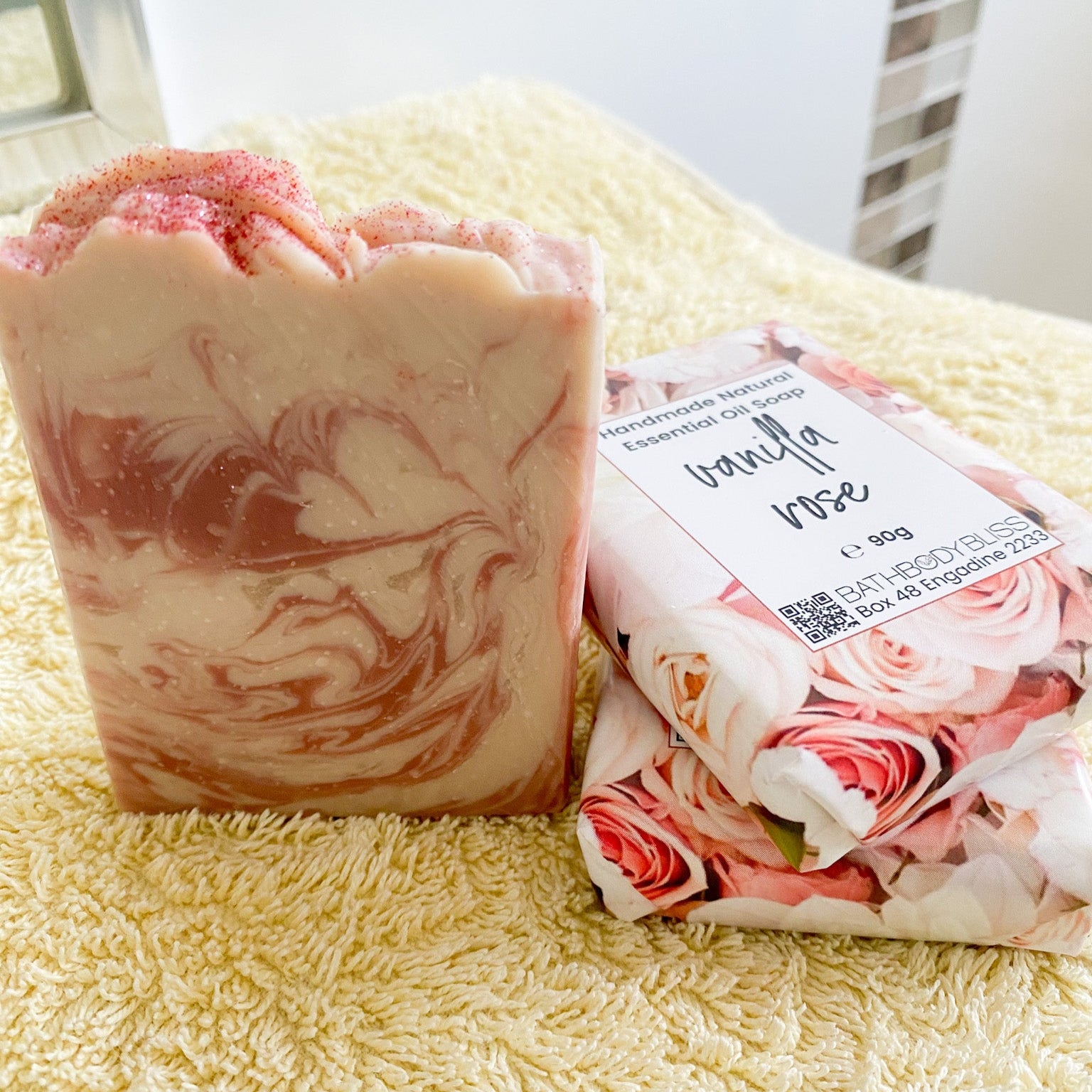Bar of soap with a floral design on a yellow towel