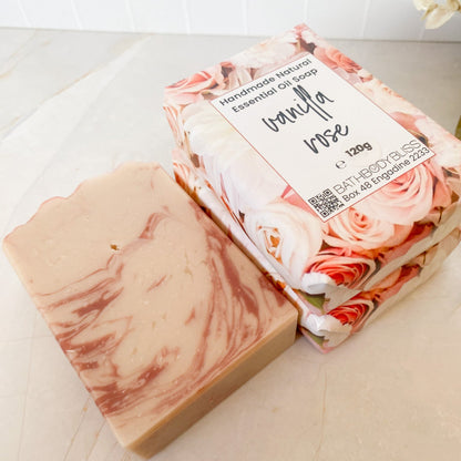 Marbled soap bar and floral soap packaging on a marble surface