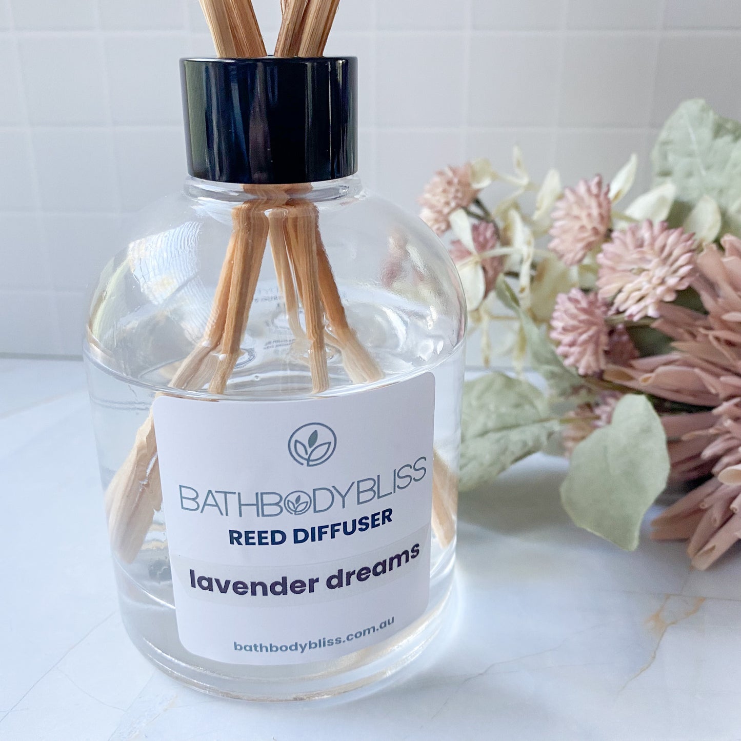 Bathbody Bliss reed diffuser labeled 'Lavender Dreams' with wooden sticks on a white surface.