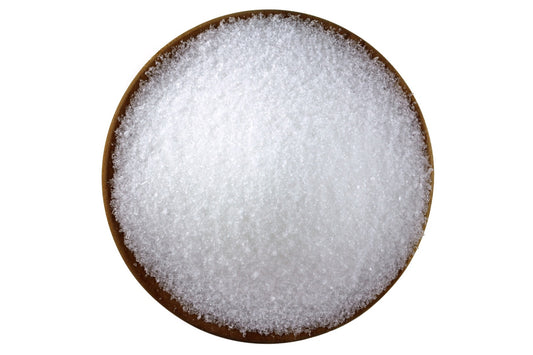 brown bowl of white epsom salts on a white background