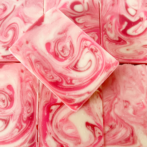 Pink and white swirled soap bars stacked together