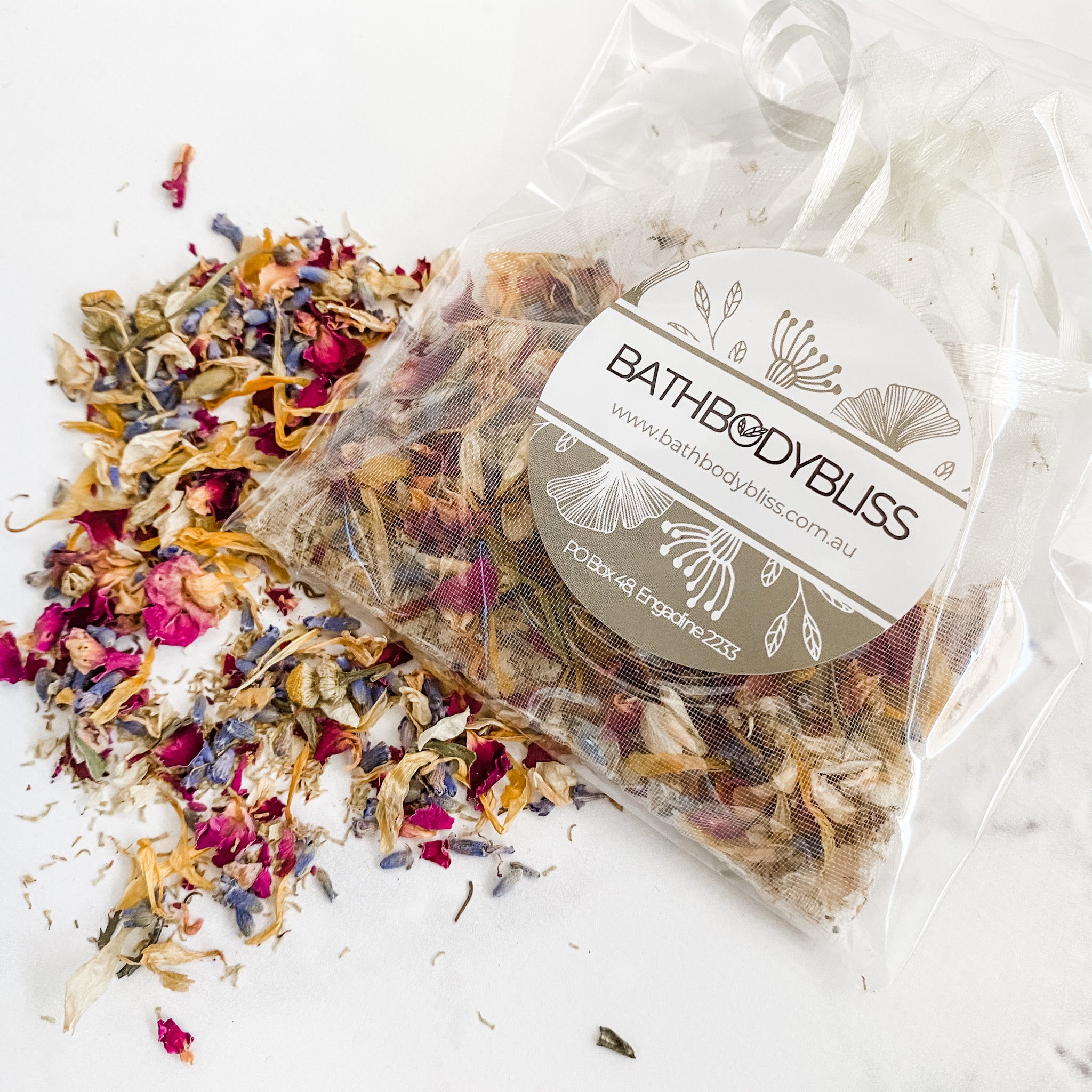 floral bath tea loose on a white background and packaged in organza and cello bag with bathbodybliss label