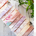 A set of handmade natural soaps with different swirl designs, displayed on a white wooden surface