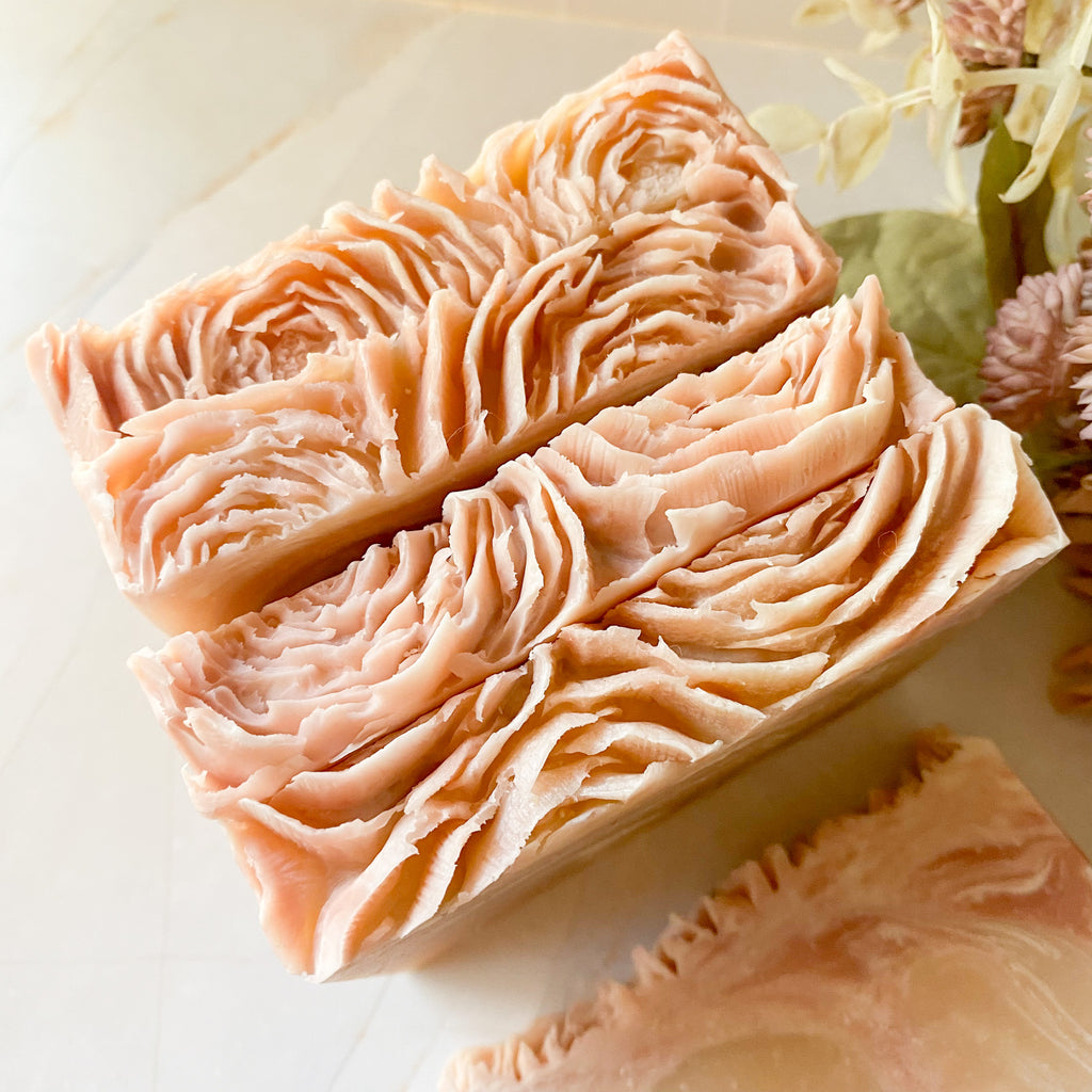 Two bars of decorative soap with a wavy pattern on a light background