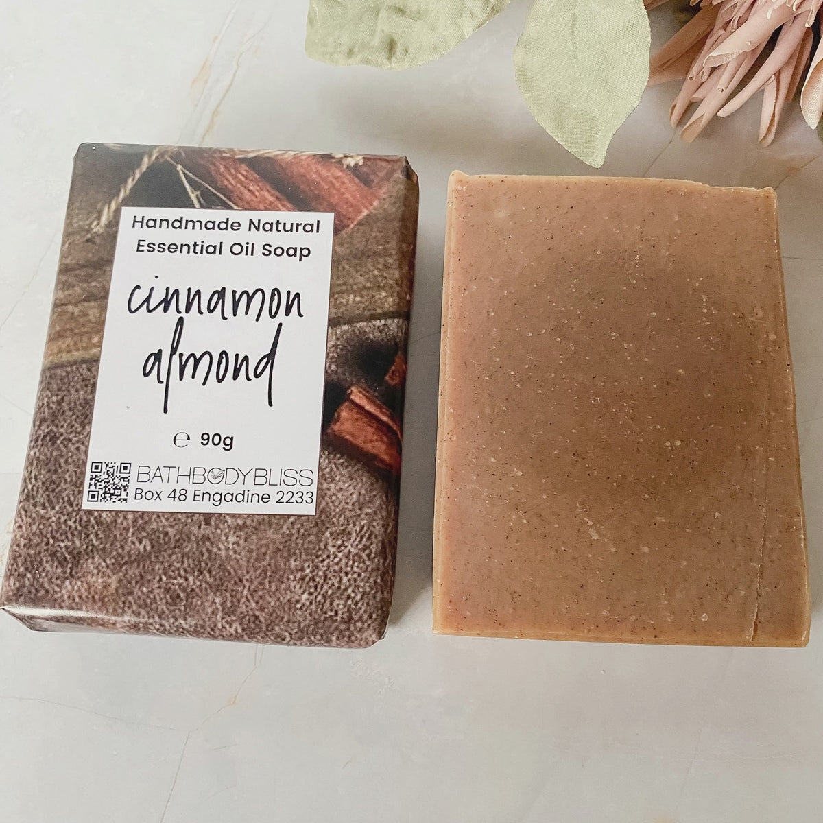 animated image of one wrapped and one unwrapped cinnamon almond handmade soap bars