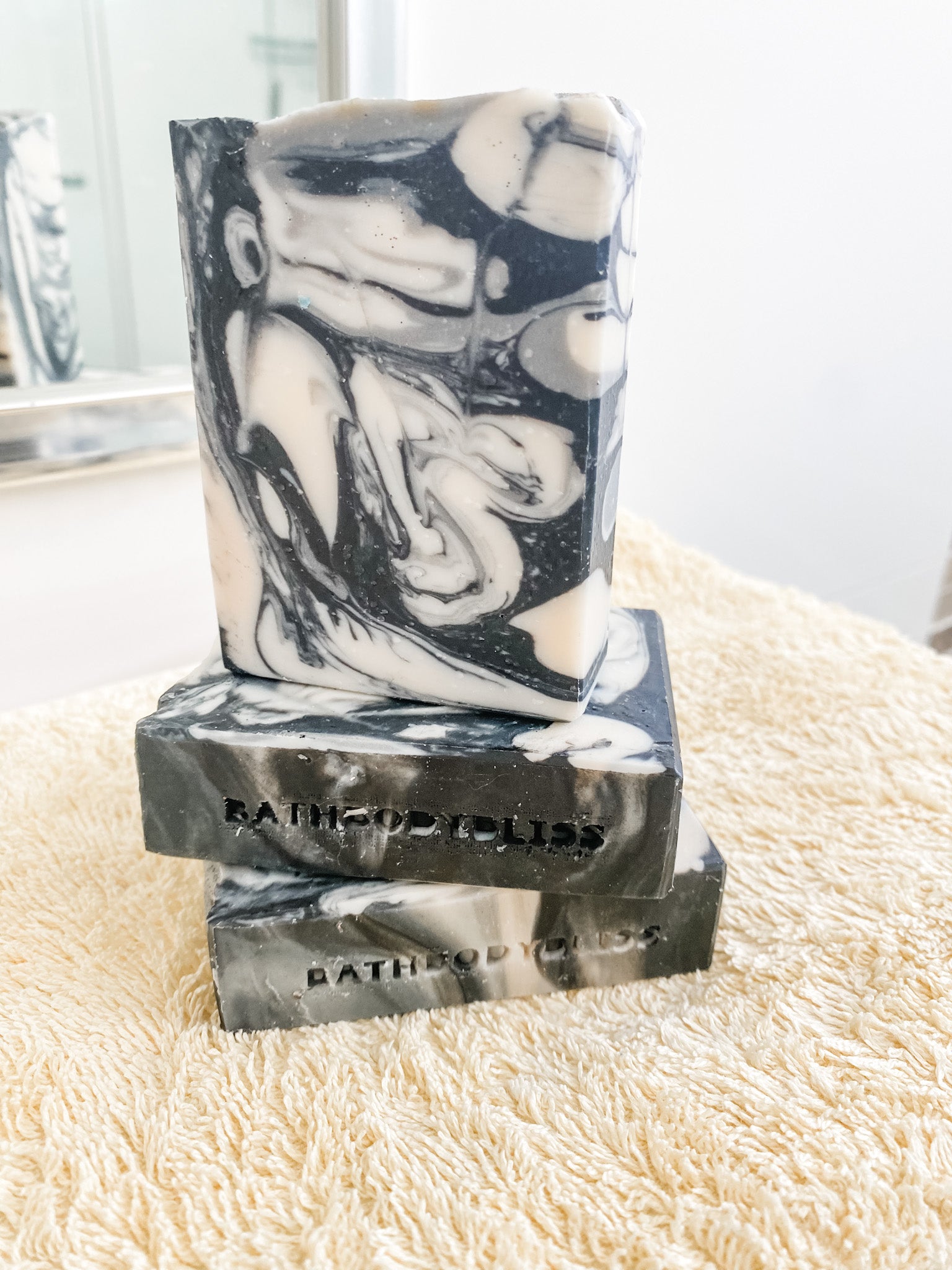 black and white marble pattern handmade soap bars on a yellow towel