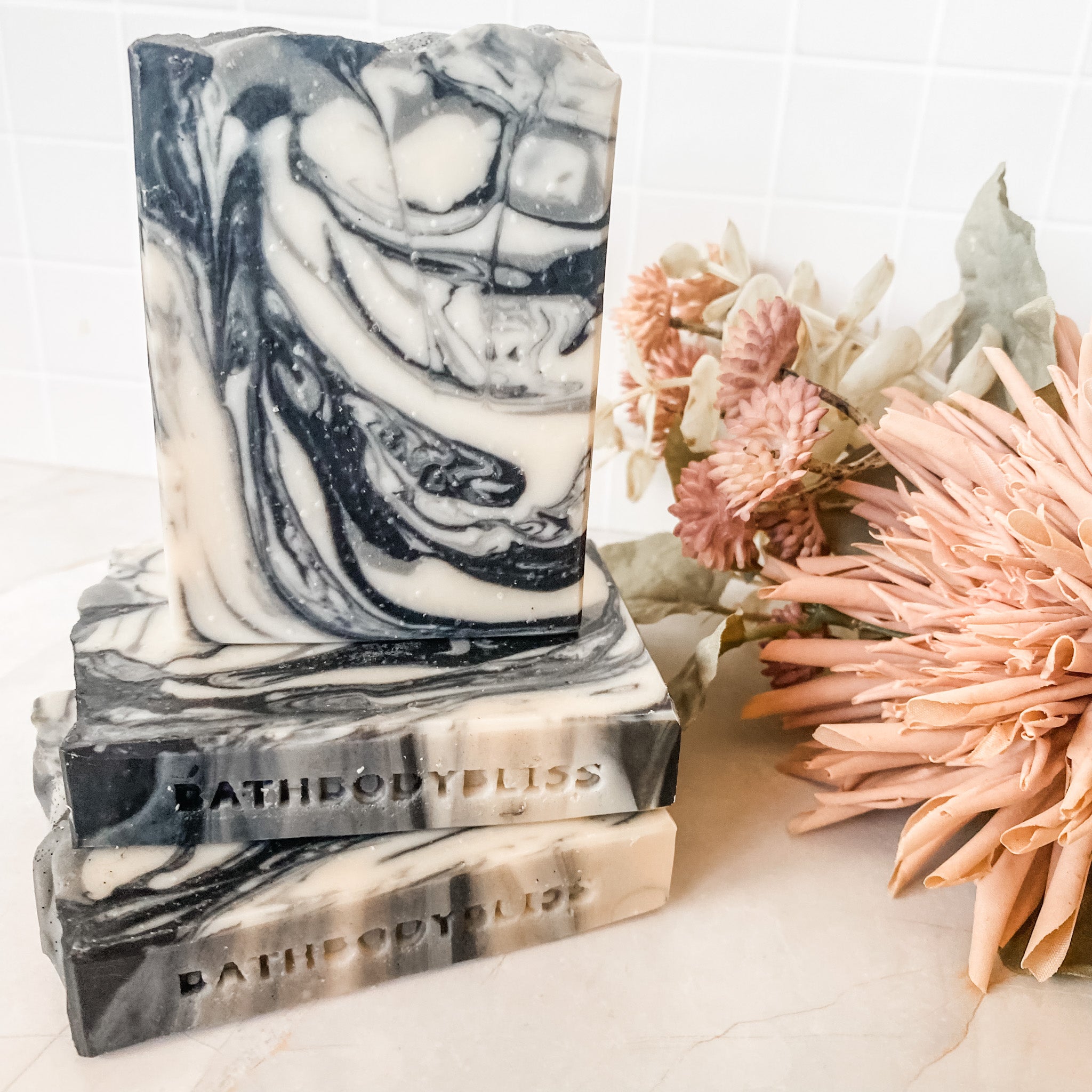 black and white marbled soap bars with floral decor