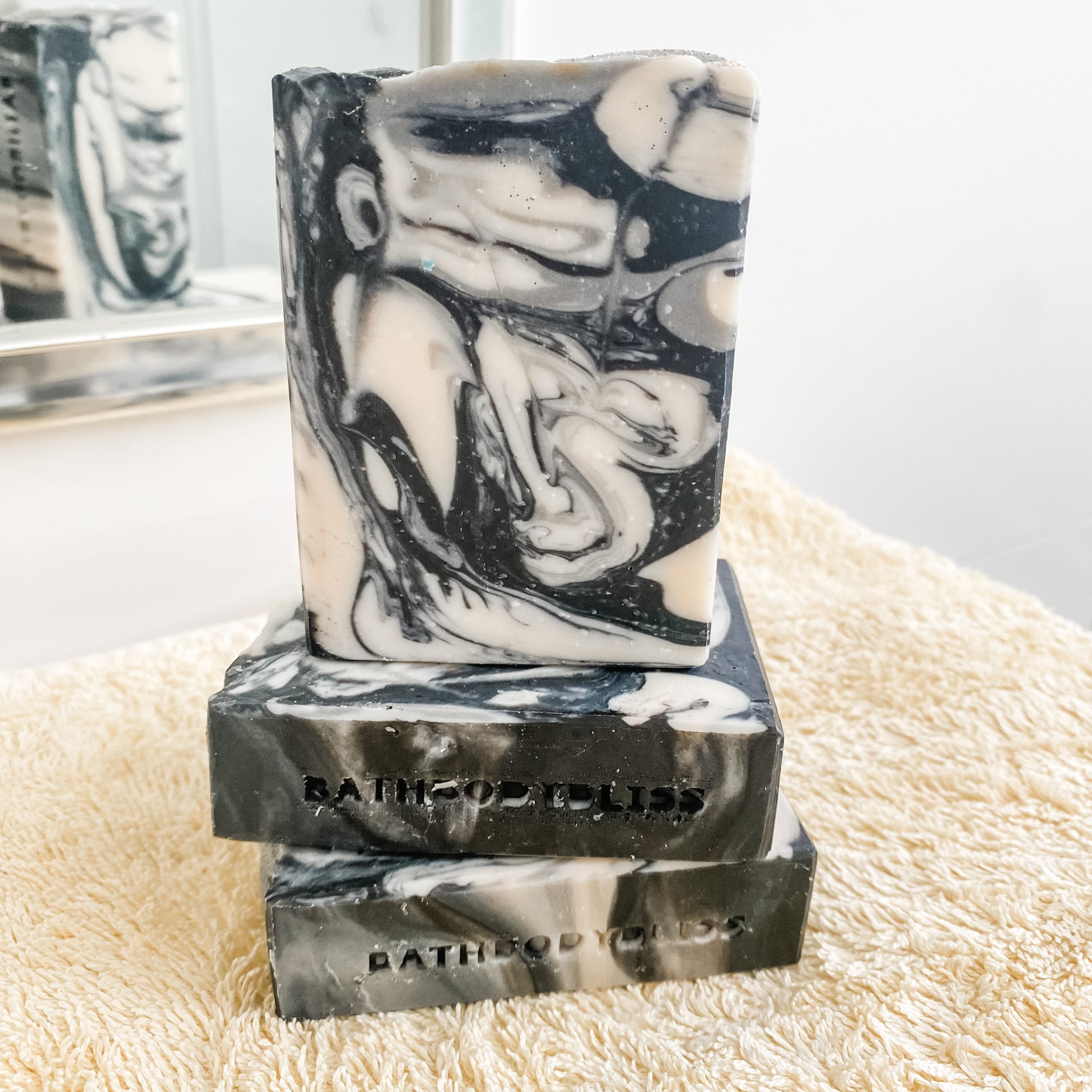 black and white marbled soap bars on a yellow towel