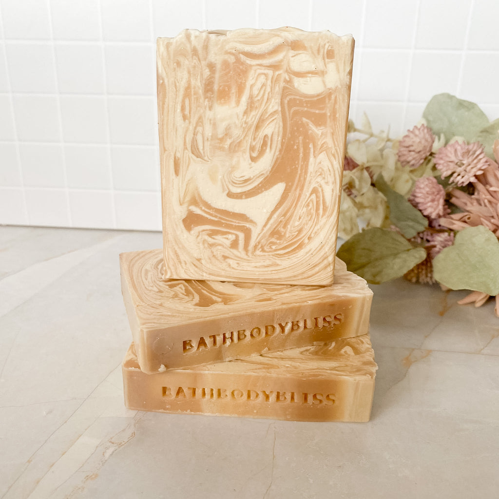Three swirled soap bars with 'BATHBODYBLISS' branding on a light surface.